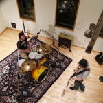 Musicians playing guitar and drums in the live recording room. Landslide Recording Studios Asheville - North Carolina