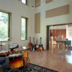 Live room with guitars against the back wall and drumkit in foreground. Landslide Recording Studio in Asheville NC.